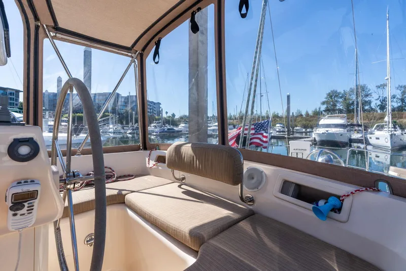 Easy Going Yacht Photos Pics Interior view of 2008 Island Packet 465 sailboat cockpit with marina background.