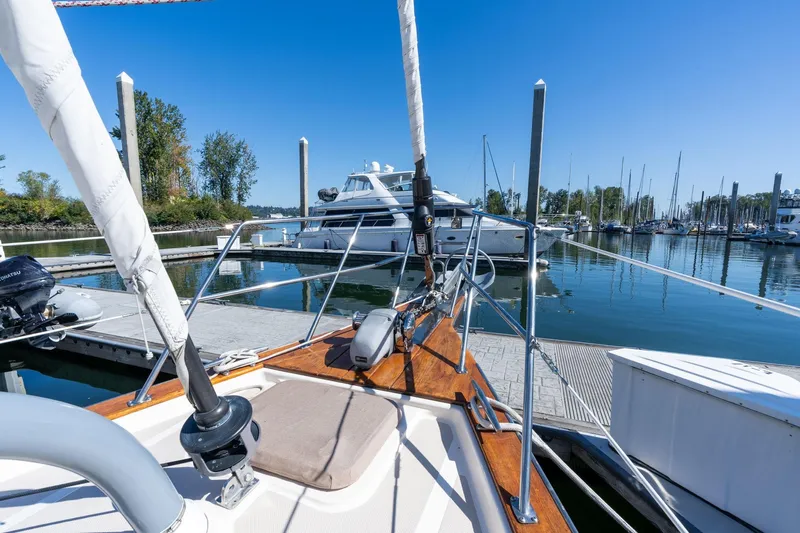 Easy Going Yacht Photos Pics Sailboat Island Packet 465, 2008 model, docked in a serene marina setting.
