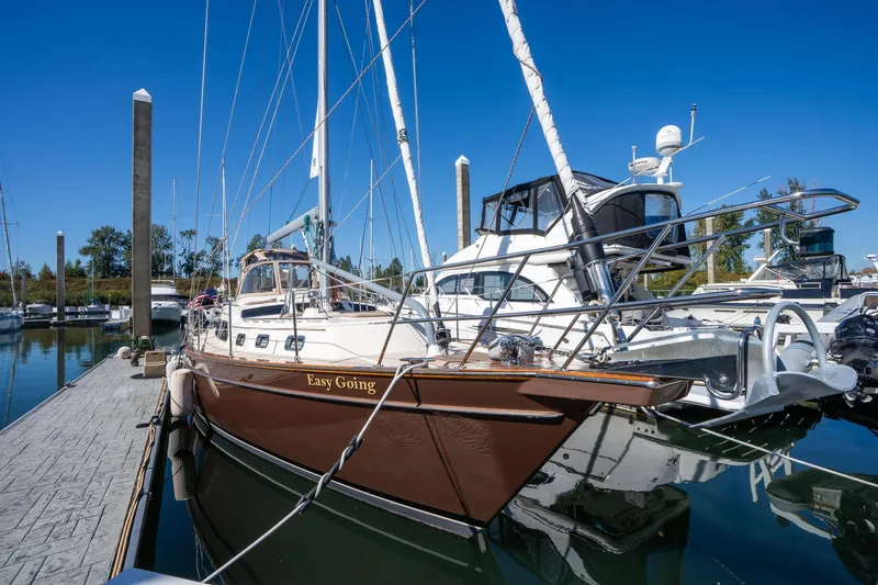 Easy Going Yacht Photos Pics 2008 Island Packet 465 sailboat docked at marina under clear blue sky.