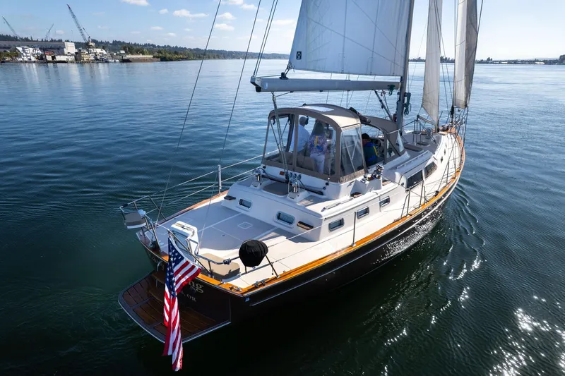 Easy Going Yacht Photos Pics 2008 Island Packet 465 sailboat cruising on calm waters with American flag.