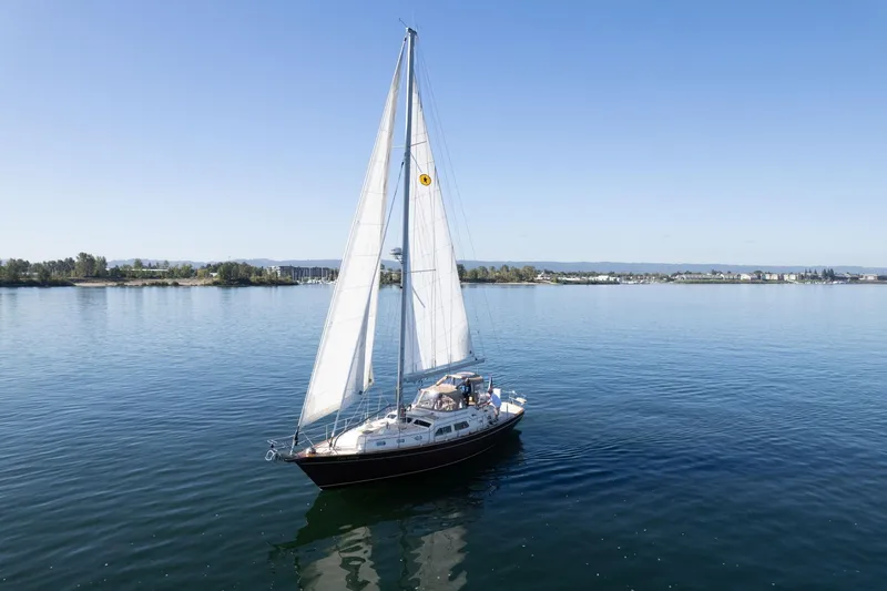 Easy Going Yacht Photos Pics 2008 Island Packet 465 sailboat cruising on calm waters under clear blue skies.