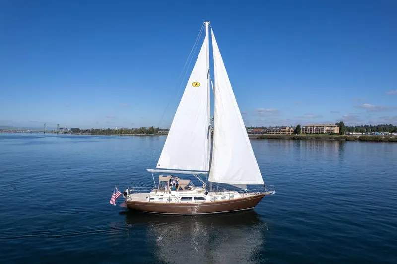 Easy Going Yacht Photos Pics 2008 Island Packet 465 sailboat cruising on calm waters under clear blue skies.