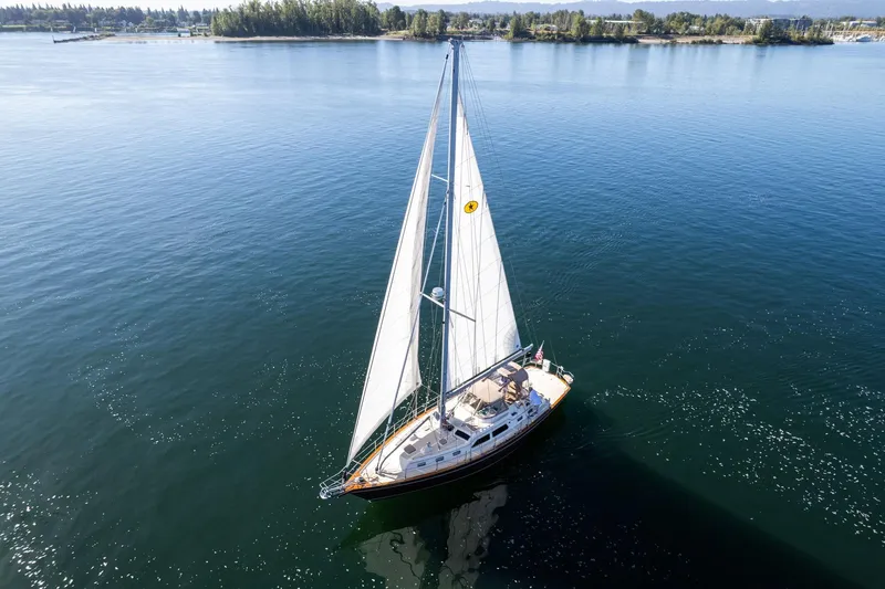 Easy Going Yacht Photos Pics Sailing yacht Island Packet 465, 2008 model, gliding on calm waters under clear skies.