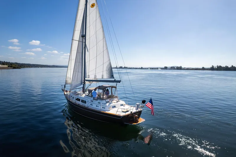 Easy Going Yacht Photos Pics Sailing yacht Island Packet 465, 2008 model, cruising on calm waters under clear skies.