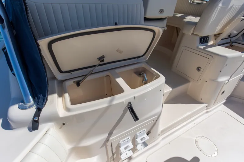  Yacht Photos Pics 2009 Grady-White 330 Express boat interior with open storage compartment and sink.