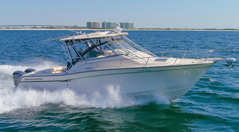  Yacht Photos Pics 2009 Grady-White 330 Express boat cruising on open water, clear sky background.