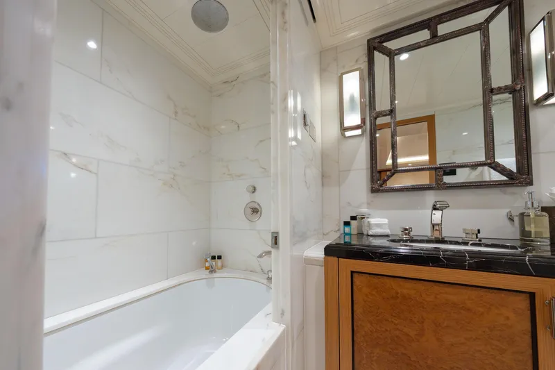 Latitude Yacht Photos Pics Luxurious bathroom on 2009 Timmerman Expedition Tri-Deck yacht with marble tiles and elegant fixtures.