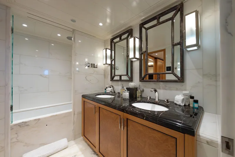 Latitude Yacht Photos Pics Luxurious bathroom on 2009 Timmerman Expedition Tri-Deck yacht with marble accents and dual sinks.
