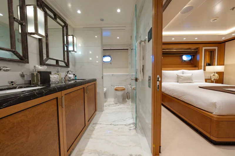 Latitude Yacht Photos Pics Luxurious 2009 Timmerman Expedition Tri-Deck yacht interior with elegant bedroom and bathroom.