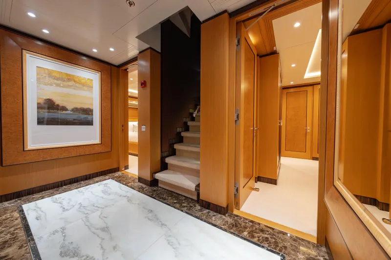 Latitude Yacht Photos Pics Luxurious interior of 2009 Timmerman Expedition Tri-Deck yacht with elegant wood paneling and artwork.