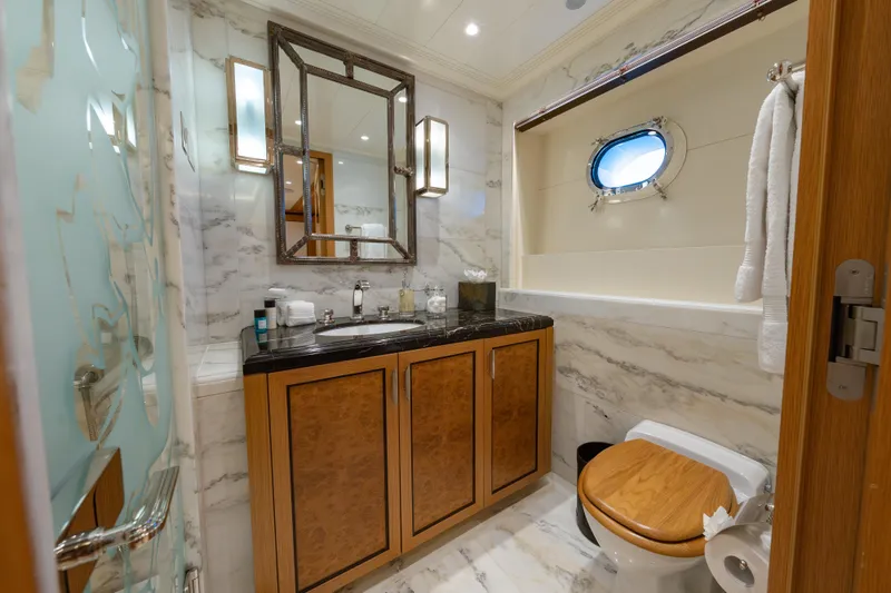 Latitude Yacht Photos Pics Luxurious bathroom on 2009 Timmerman Expedition Tri-Deck yacht with marble and wood accents.