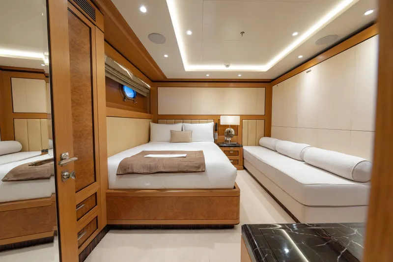 Latitude Yacht Photos Pics Luxurious bedroom on 2009 Timmerman Expedition Tri-Deck yacht, featuring elegant wood and modern design.