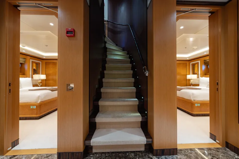 Latitude Yacht Photos Pics Luxurious interior of 2009 Timmerman Expedition Tri-Deck yacht with elegant bedrooms and staircase.