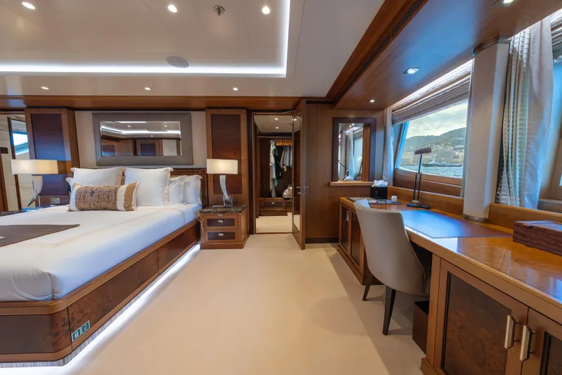 Latitude Yacht Photos Pics Luxurious 2009 Timmerman Expedition Tri-Deck yacht bedroom with elegant wood furnishings.