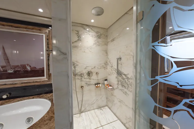 Latitude Yacht Photos Pics Luxurious marble bathroom on 2009 Timmerman Expedition Tri-Deck yacht with elegant shower and bathtub.