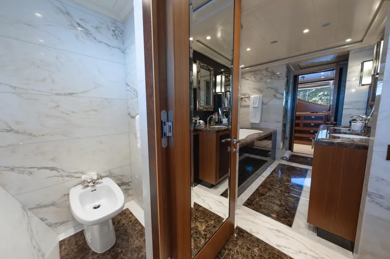 Latitude Yacht Photos Pics Luxurious bathroom on 2009 Timmerman Expedition Tri-Deck yacht with marble finishes and elegant fixtures.