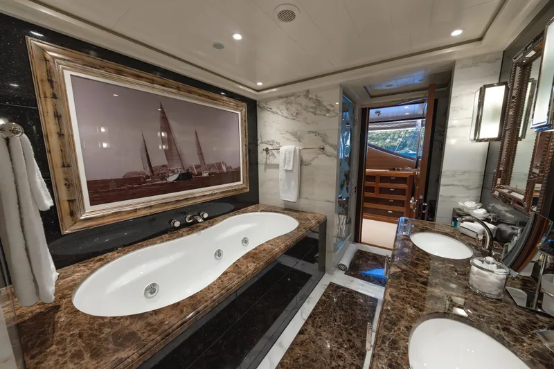 Latitude Yacht Photos Pics Luxurious bathroom on 2009 Timmerman Expedition Tri-Deck yacht with marble finishes and elegant decor.