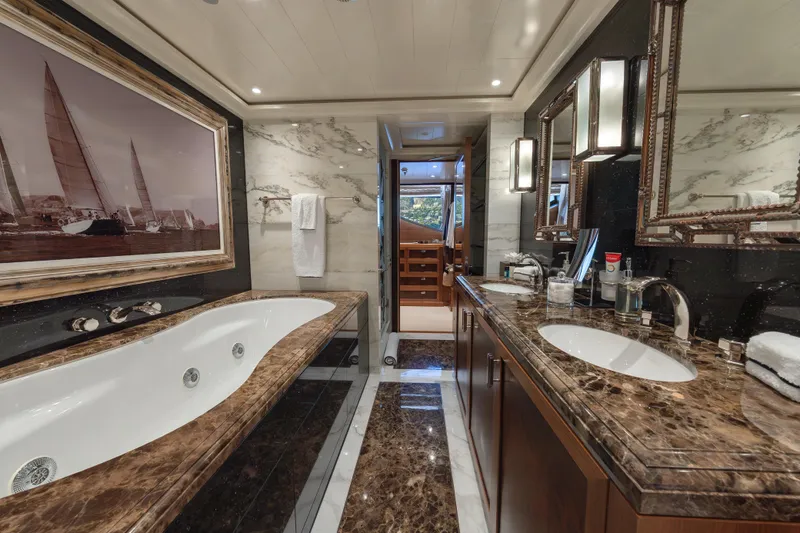 Latitude Yacht Photos Pics Luxurious bathroom on 2009 Timmerman Expedition Tri-Deck yacht with marble finishes and elegant decor.