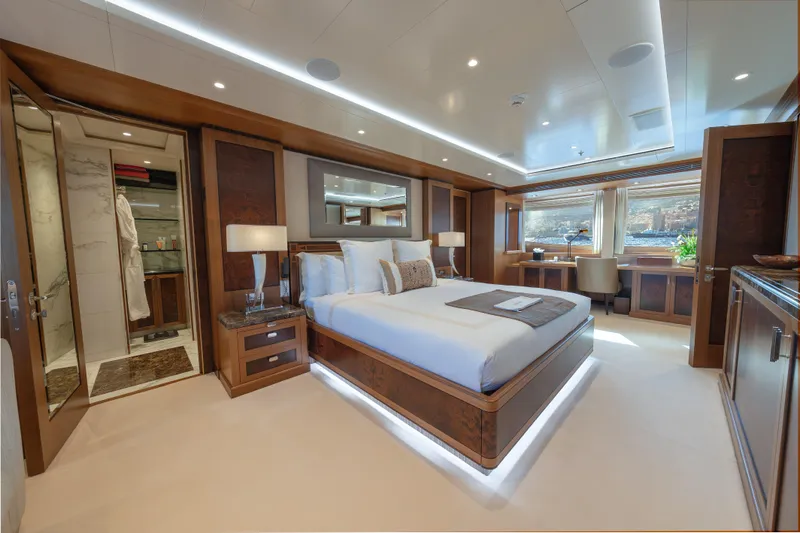 Latitude Yacht Photos Pics Luxurious bedroom on 2009 Timmerman Expedition Tri-Deck yacht with elegant wood finishes.