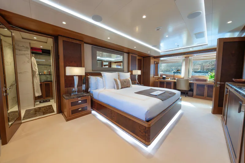 Latitude Yacht Photos Pics Luxurious bedroom on 2009 Timmerman Expedition Tri-Deck yacht with elegant wood finishes.