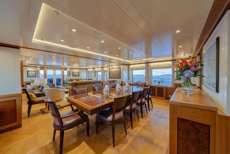 Latitude Yacht Photos Pics Luxurious dining area on 2009 Timmerman Expedition Tri-Deck yacht, featuring elegant wood furnishings.