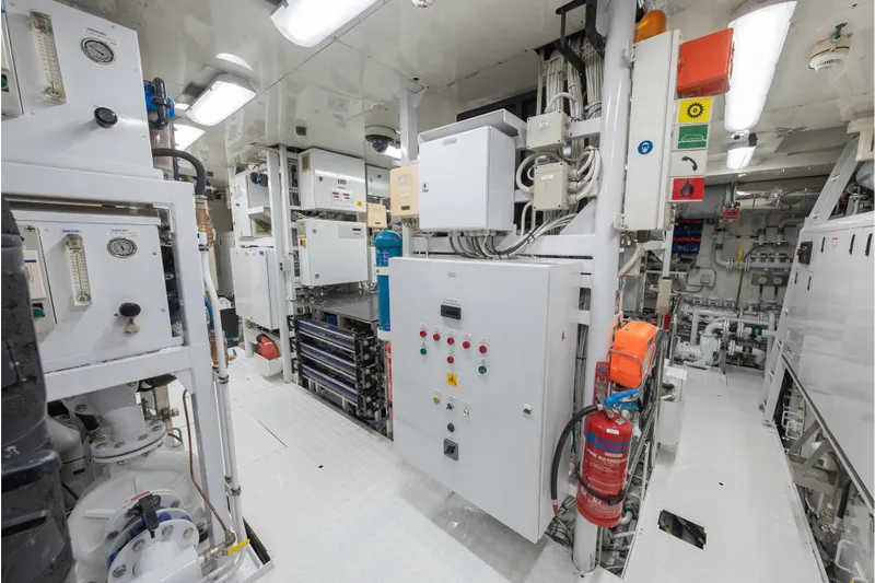 Latitude Yacht Photos Pics Engine room of 2009 Timmerman Expedition Tri-Deck yacht with control panels and safety equipment.