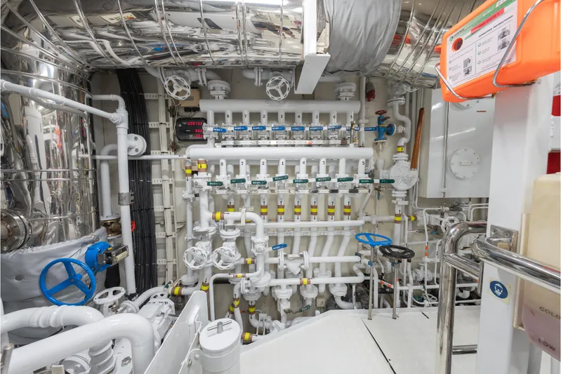 Latitude Yacht Photos Pics Engine room of 2009 Timmerman Expedition Tri-Deck yacht with complex piping and valves.