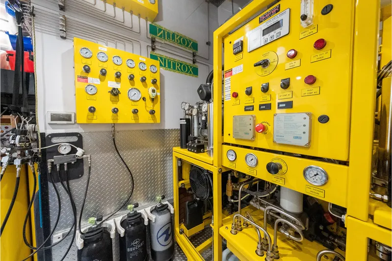 Latitude Yacht Photos Pics Engine room of 2009 Timmerman Expedition Tri-Deck yacht with control panels and gauges.