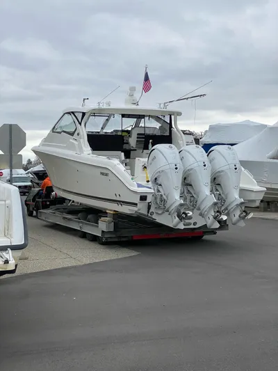  Yacht Photos Pics 2022 Pursuit DC 365 boat with triple outboard engines on trailer.