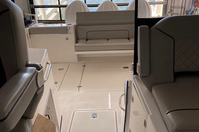  Yacht Photos Pics Interior of a 2022 Pursuit DC 365 boat with seating and storage compartments.