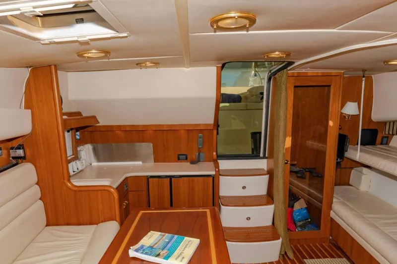 Brown Eyed Girl Yacht Photos Pics Interior of 2004 Pursuit 3800 Express yacht with wood finishes and cozy seating.