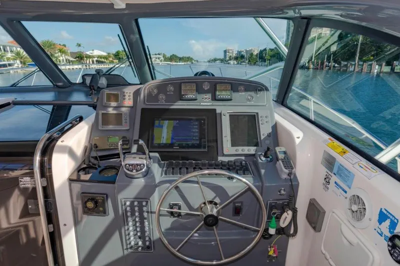 Brown Eyed Girl Yacht Photos Pics Cockpit of 2004 Pursuit 3800 Express boat with navigation equipment and steering wheel.