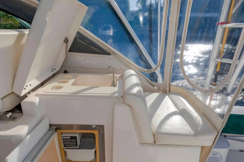 Brown Eyed Girl Yacht Photos Pics 2004 Pursuit 3800 Express boat interior with sink and seating area.