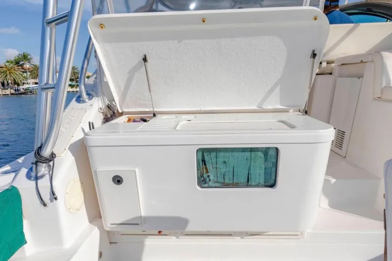 Brown Eyed Girl Yacht Photos Pics 2004 Pursuit 3800 Express boat with open storage compartment, dockside view.