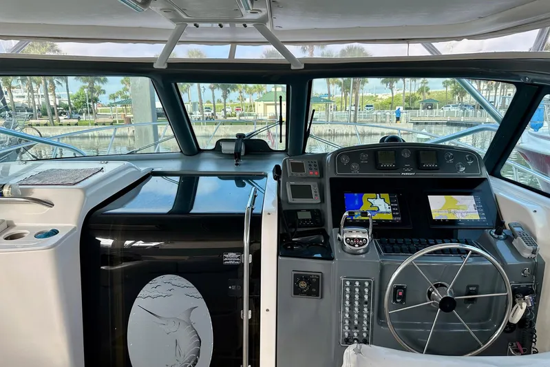Brown Eyed Girl Yacht Photos Pics Interior view of a 2004 Pursuit 3800 Express boat cockpit with navigation equipment.