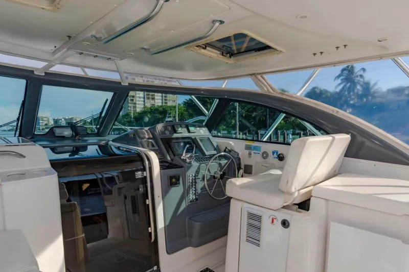 Brown Eyed Girl Yacht Photos Pics Interior view of 2004 Pursuit 3800 Express yacht cockpit with steering wheel and seating.