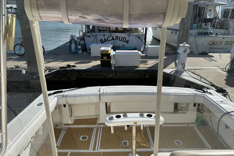 Brown Eyed Girl Yacht Photos Pics 2004 Pursuit 3800 Express boat docked at marina with fishing equipment.