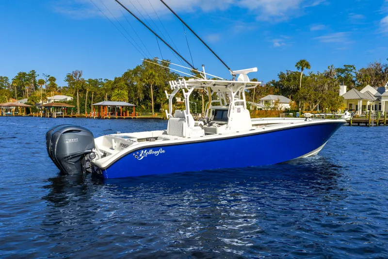  Yacht Photos Pics 2014 Yellowfin 32 Offshore boat on water, blue hull, twin Yamaha engines.