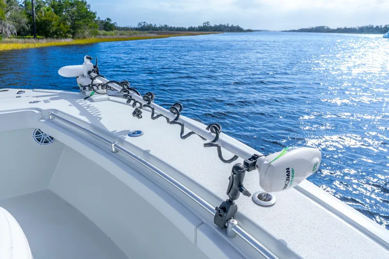  Yacht Photos Pics 2014 Yellowfin 32 Offshore boat on serene water with clear blue sky.