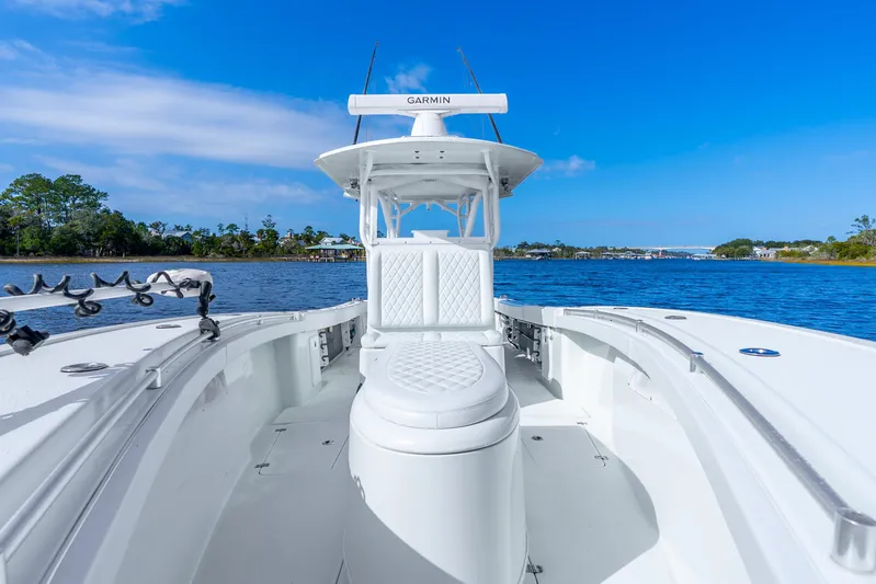  Yacht Photos Pics 2014 Yellowfin 32 Offshore boat on calm water under clear blue sky.