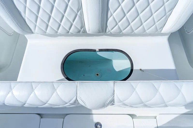  Yacht Photos Pics 2014 Yellowfin 32 Offshore boat with quilted white seating and oval storage compartment.