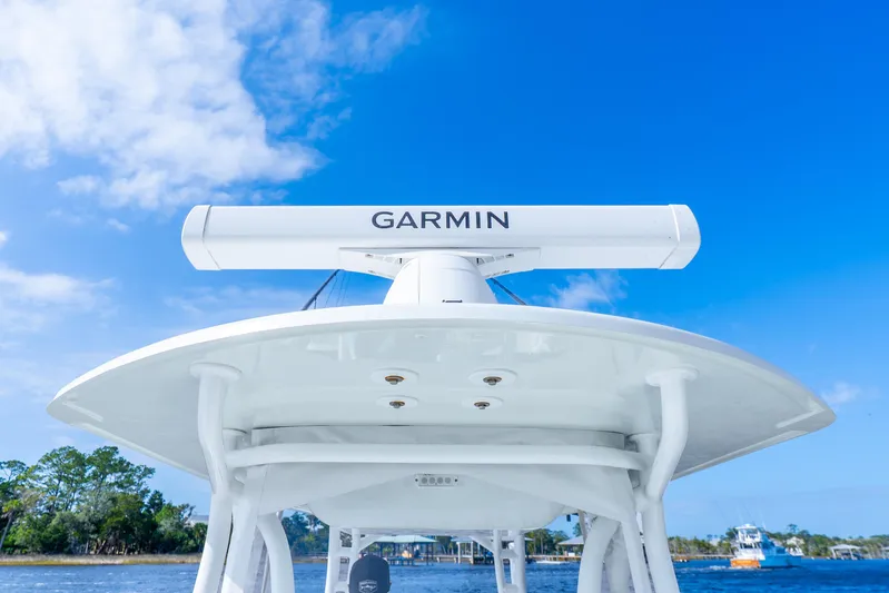  Yacht Photos Pics 2014 Yellowfin 32 Offshore boat with Garmin radar against blue sky.