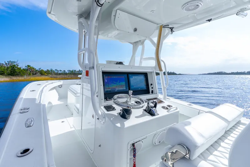  Yacht Photos Pics 2014 Yellowfin 32 Offshore boat interior with navigation system on a sunny day.