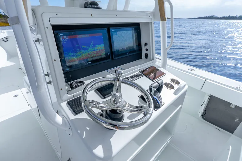  Yacht Photos Pics 2014 Yellowfin 32 Offshore boat helm with dual displays and steering wheel.