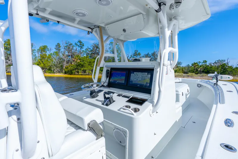  Yacht Photos Pics 2014 Yellowfin 32 Offshore boat interior with navigation screens and steering wheel.