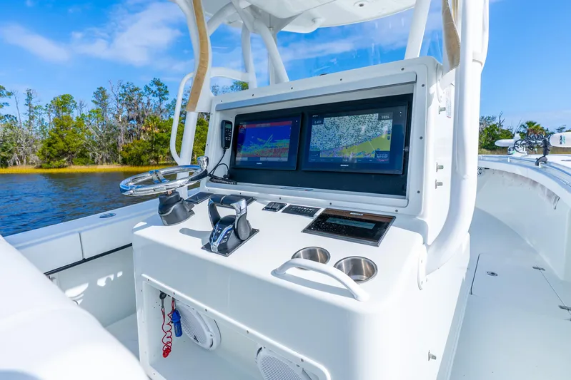  Yacht Photos Pics 2014 Yellowfin 32 Offshore boat console with dual navigation screens on a sunny day.