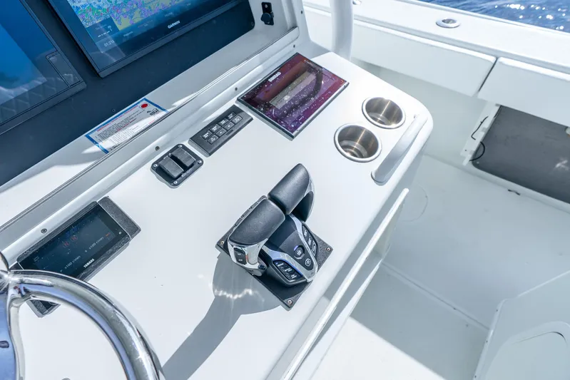  Yacht Photos Pics Control panel of 2014 Yellowfin 32 Offshore boat with navigation screens and throttle.