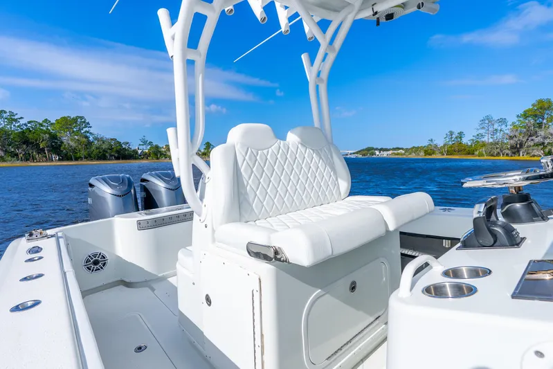  Yacht Photos Pics 2014 Yellowfin 32 Offshore boat interior with white seating, dual engines, and scenic water view.