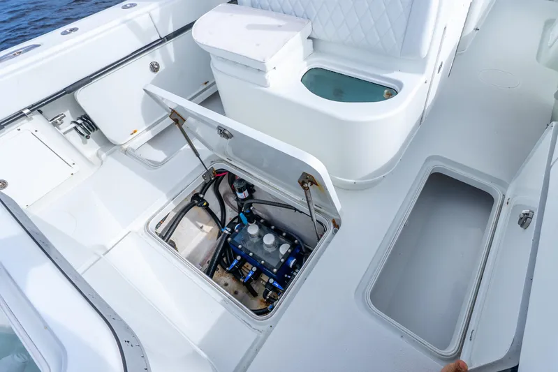  Yacht Photos Pics 2014 Yellowfin 32 Offshore boat interior with open storage compartments and seating.