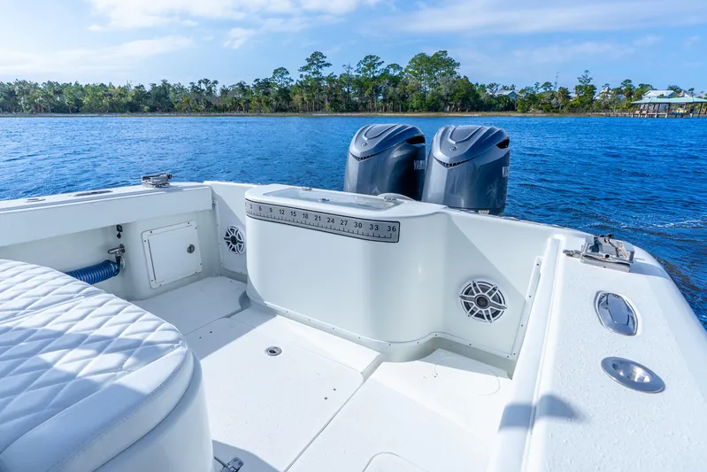  Yacht Photos Pics 2014 Yellowfin 32 Offshore boat with dual engines on a serene lake.
